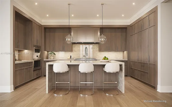 a kitchen with kitchen island granite countertop a sink and refrigerator