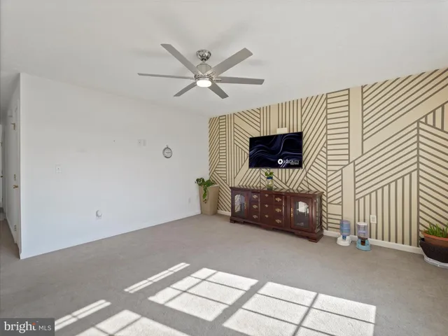 a living room with furniture a rug and a flat screen tv