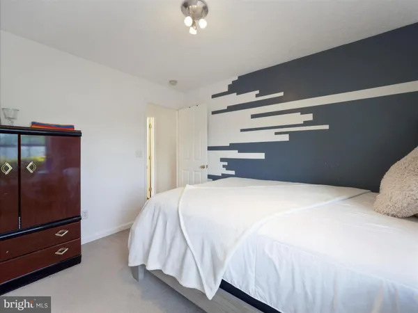 a bedroom with a bed and a dresser