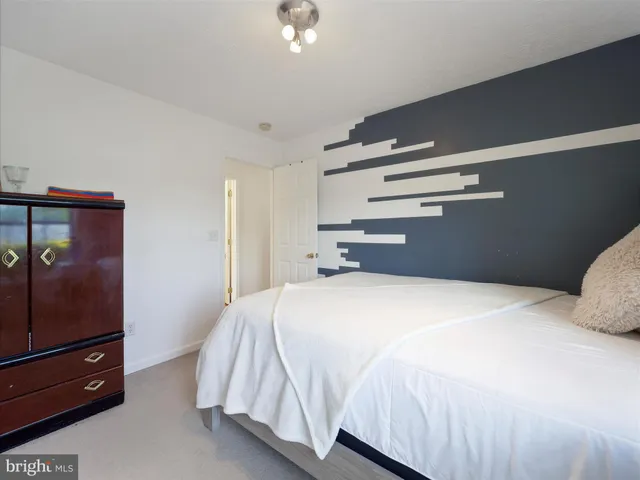 a bedroom with a bed and a dresser