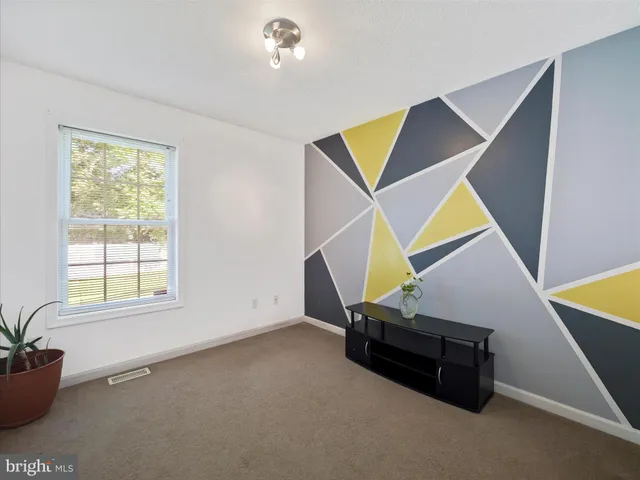 a bench sitting in a room next to a window