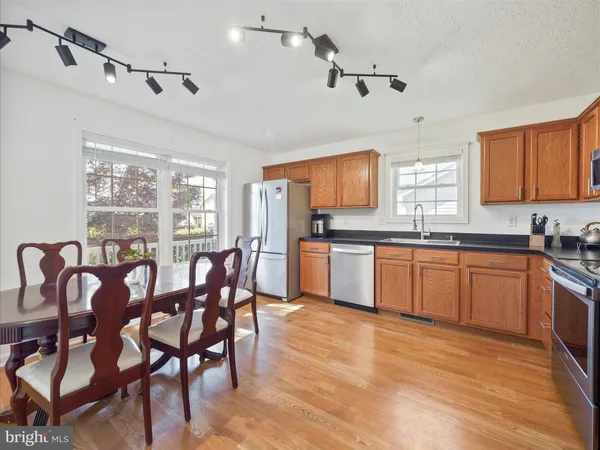 a kitchen with granite countertop a sink cabinets and window