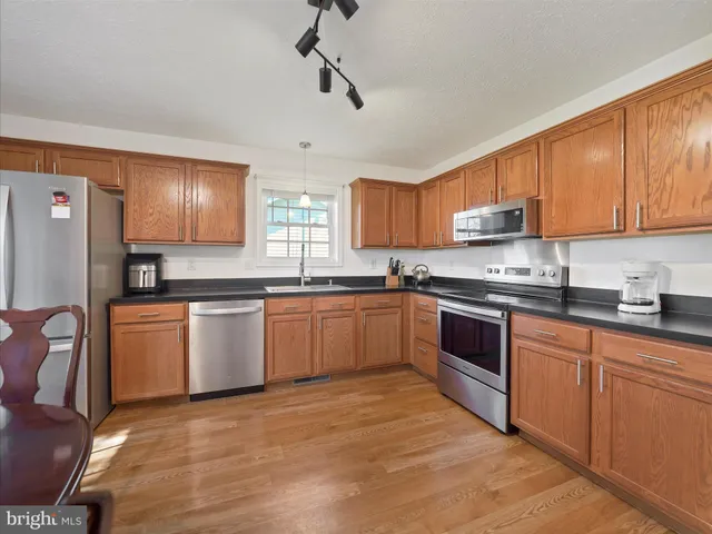 a kitchen with granite countertop a stove cabinets and a sink
