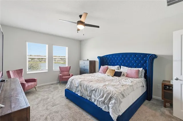 a bedroom with a bed a couch and dresser