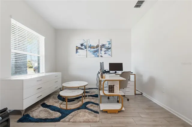 a living room with furniture a window and a table