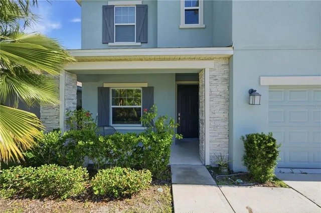 a view of a house with potted plants