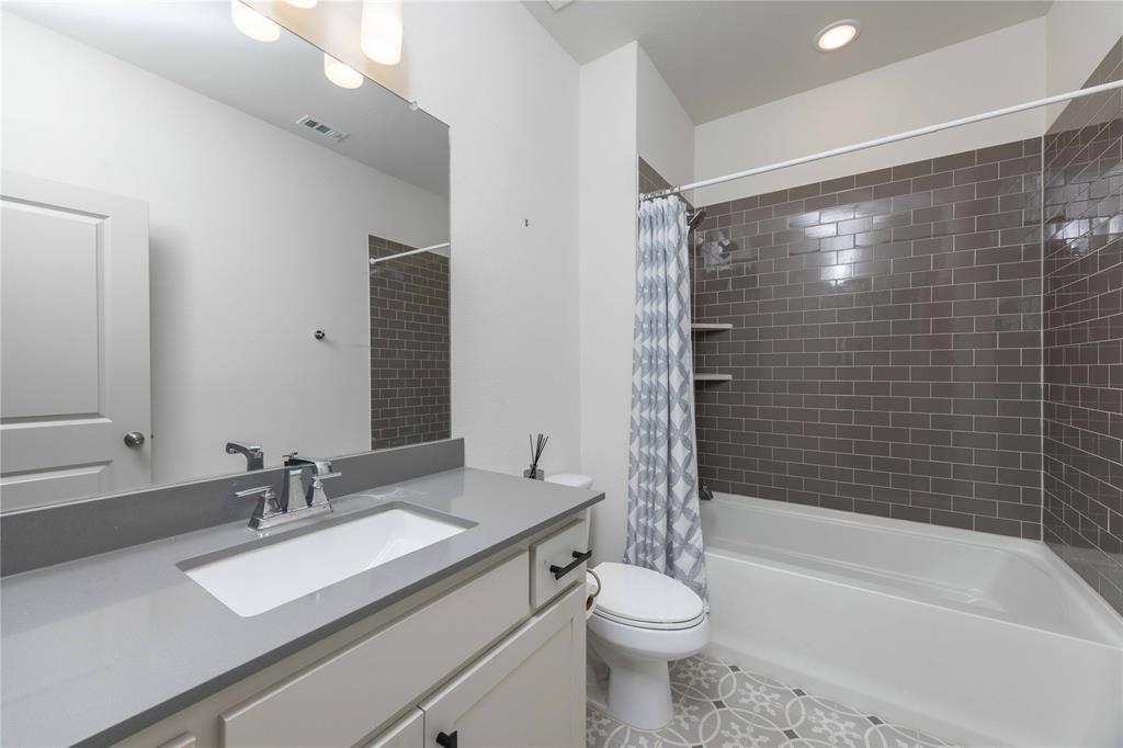 208 Spring Hill Road Flower Mound, TX 75028 - Photo 13 of 35 a bathroom with a granite countertop sink toilet and shower