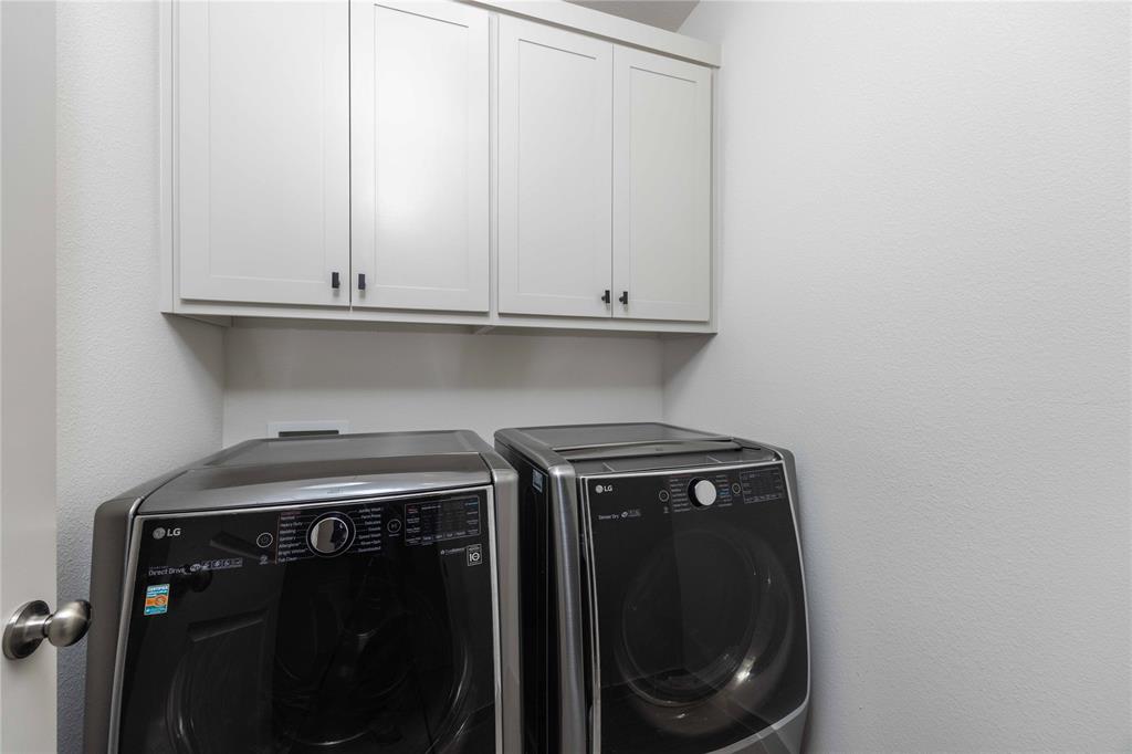 208 Spring Hill Road Flower Mound, TX 75028 - Photo 18 of 35 a utility room with dryer and washer
