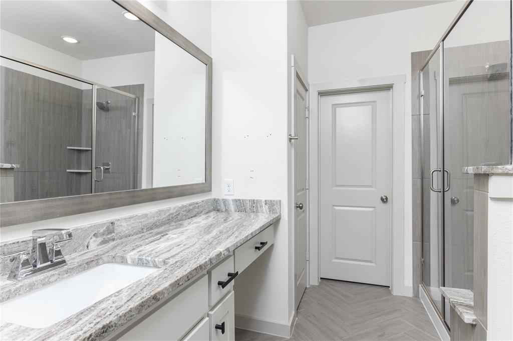208 Spring Hill Road Flower Mound, TX 75028 - Photo 22 of 35 a bathroom with a granite countertop sink and a mirror