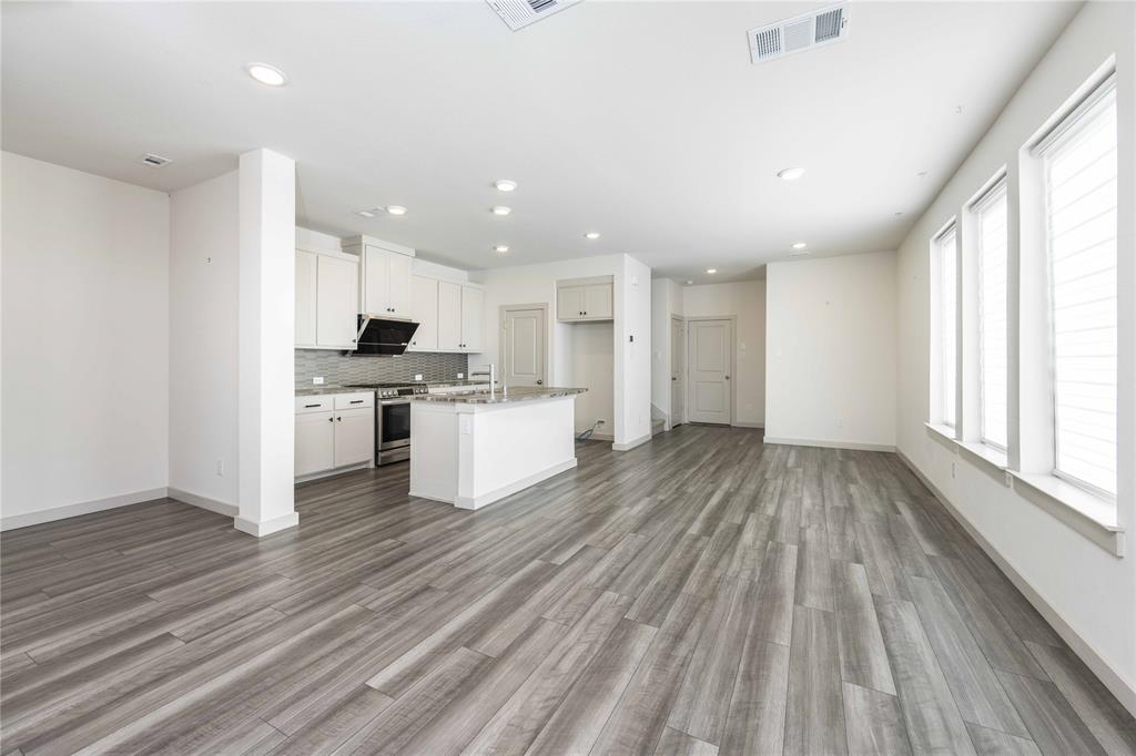 208 Spring Hill Road Flower Mound, TX 75028 - Photo 3 of 35 a view of kitchen view wooden floors appliances and cabinets