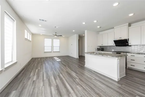 a view of kitchen with sink and wooden floor