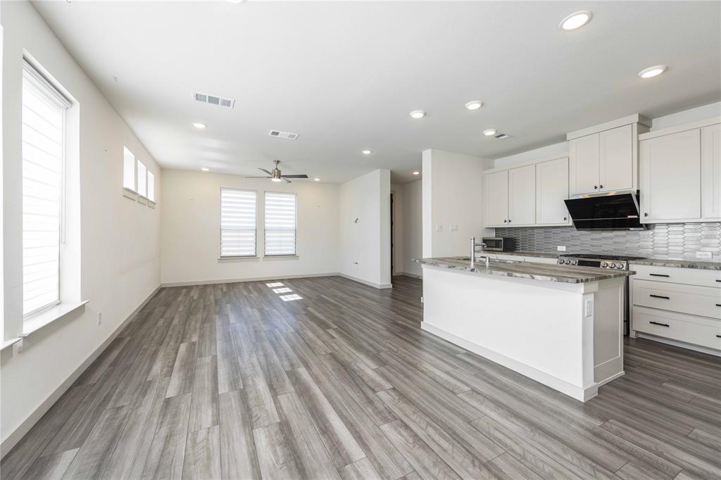 208 Spring Hill Road Flower Mound, TX 75028 - Photo 4 of 35 a view of kitchen with sink and wooden floor