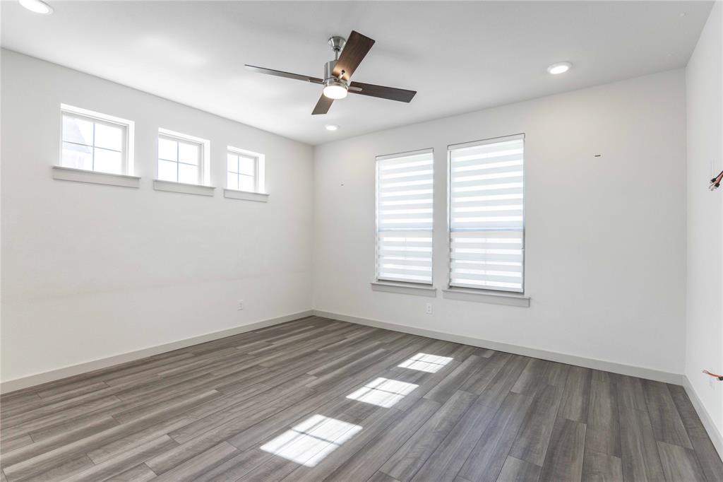 208 Spring Hill Road Flower Mound, TX 75028 - Photo 10 of 35 a view of empty room with wooden floor and fan