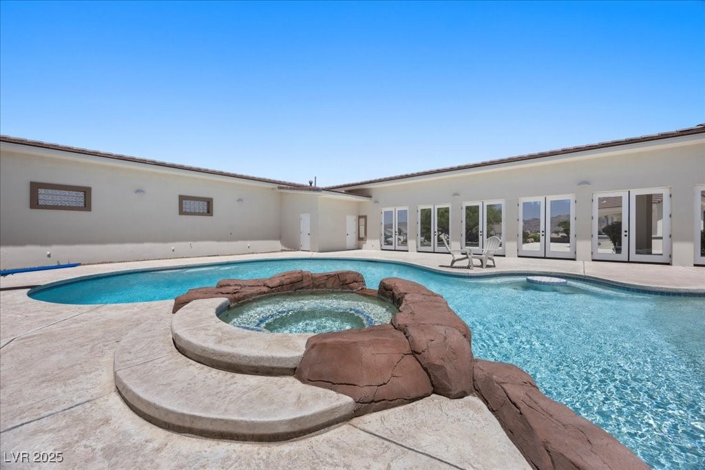 640 Quail Covey Road Henderson, NV 89002 - Photo 52 of 75 View of pool featuring french doors, a patio area, and a pool with connected hot tub