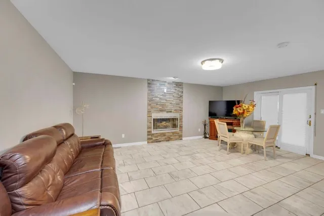a living room with furniture a window and a flat screen tv