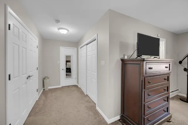 a view of a bedroom with closet flat screen tv
