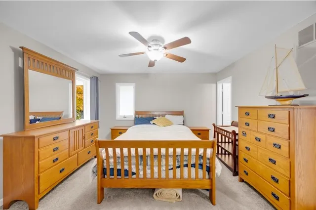 a bedroom with a bed and a dresser in it