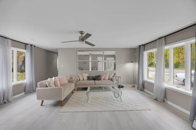 a living room with furniture and a large window