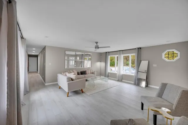 a living room with furniture and wooden floor