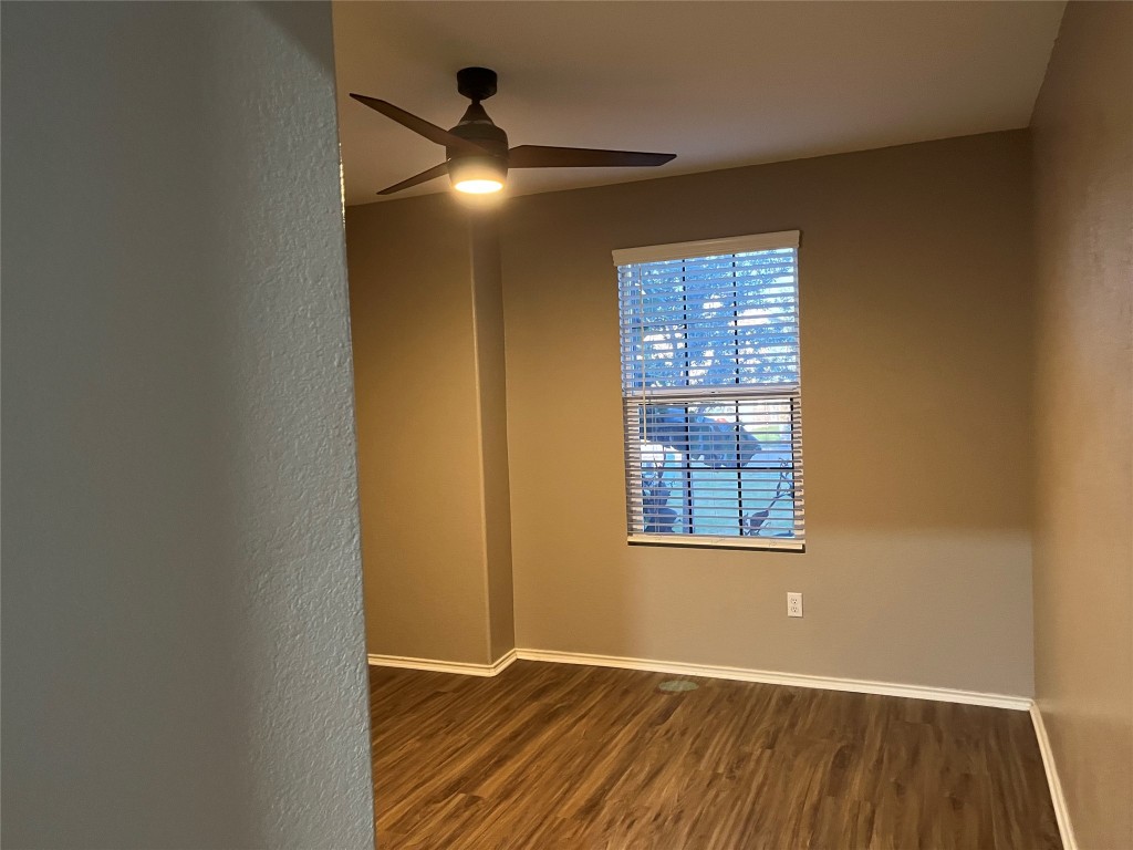 104 Granville Court Jarrell, TX 76537 - Photo 24 of 36 an empty room with wooden floor and windows