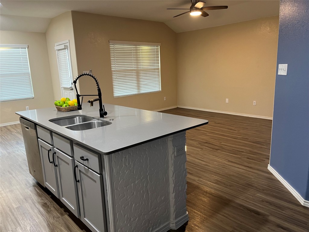 104 Granville Court Jarrell, TX 76537 - Photo 33 of 36 a kitchen with stainless steel appliances a sink cabinets and wooden floor
