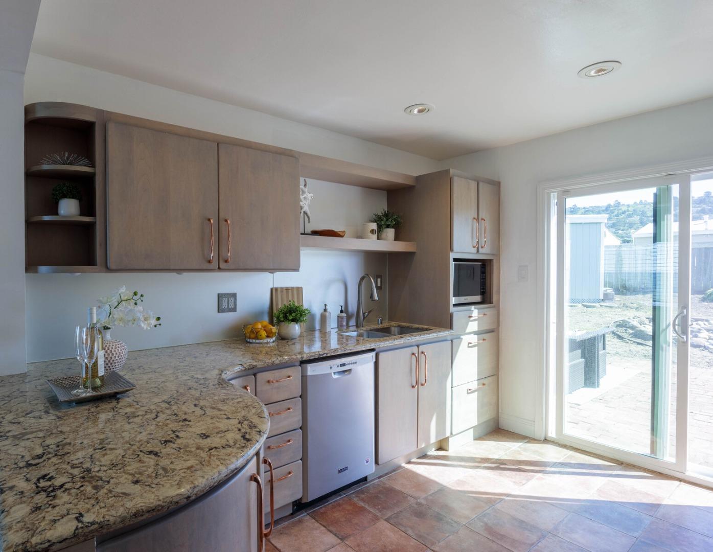 555 Esplanade Avenue Pacifica, CA 94044 - Photo 18 of 32 a kitchen with stainless steel appliances granite countertop a sink stove and refrigerator
