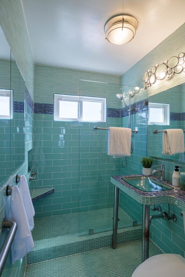 555 Esplanade Avenue Pacifica, CA 94044 - Photo 21 of 32 a bathroom with a sink mirror and a shower
