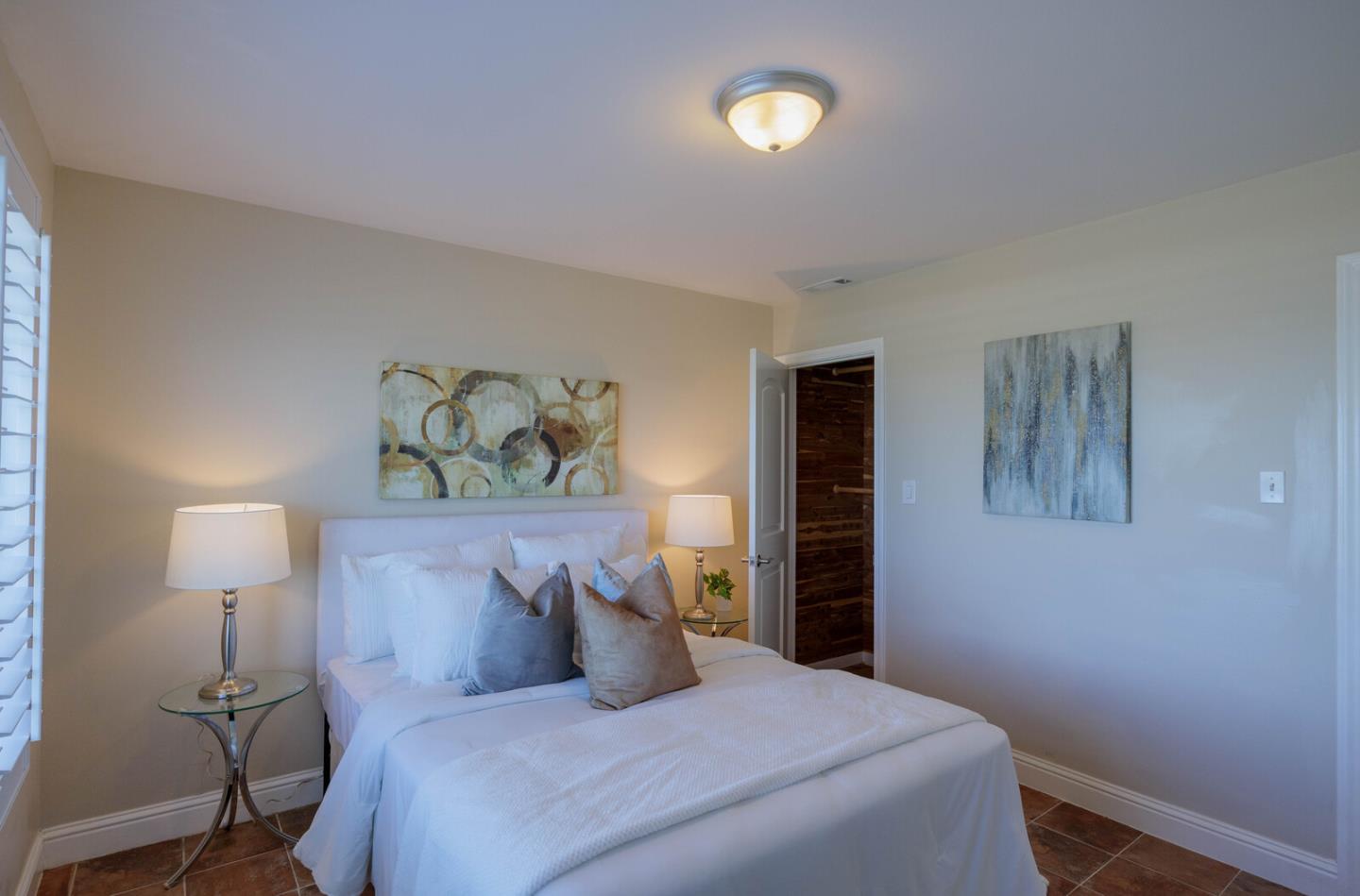 555 Esplanade Avenue Pacifica, CA 94044 - Photo 22 of 32 a bedroom with a bed and a lamp on the table