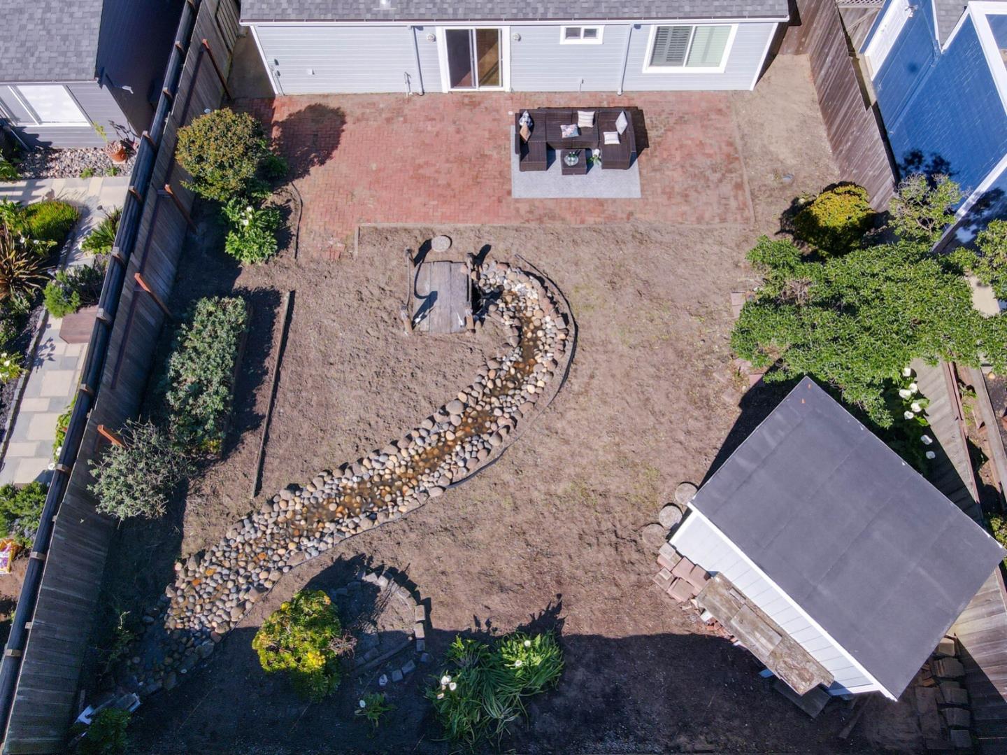 555 Esplanade Avenue Pacifica, CA 94044 - Photo 28 of 32 an aerial view of a house with a yard and a large tree