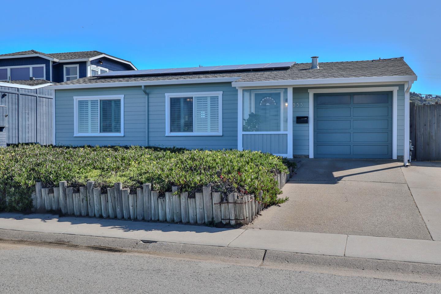 555 Esplanade Avenue Pacifica, CA 94044 - Photo 6 of 32 a front view of a house with a garage