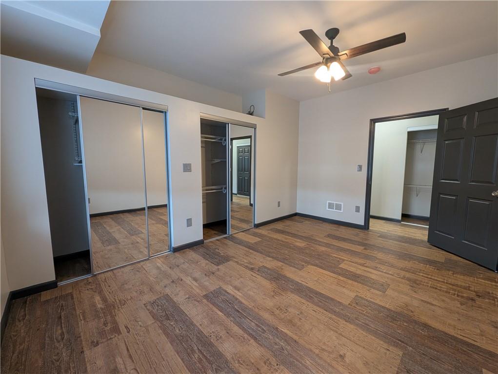 101 East Lincoln Avenue, Unit 3 McDonald, PA 15057 - Photo 7 of 14 an empty room with wooden floor and a ceiling fan