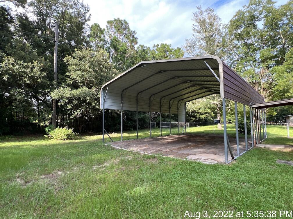 5355 Keyser Mill Road Baker, FL 32531 - Photo 12 of 16 a view of a chair and table in the garden