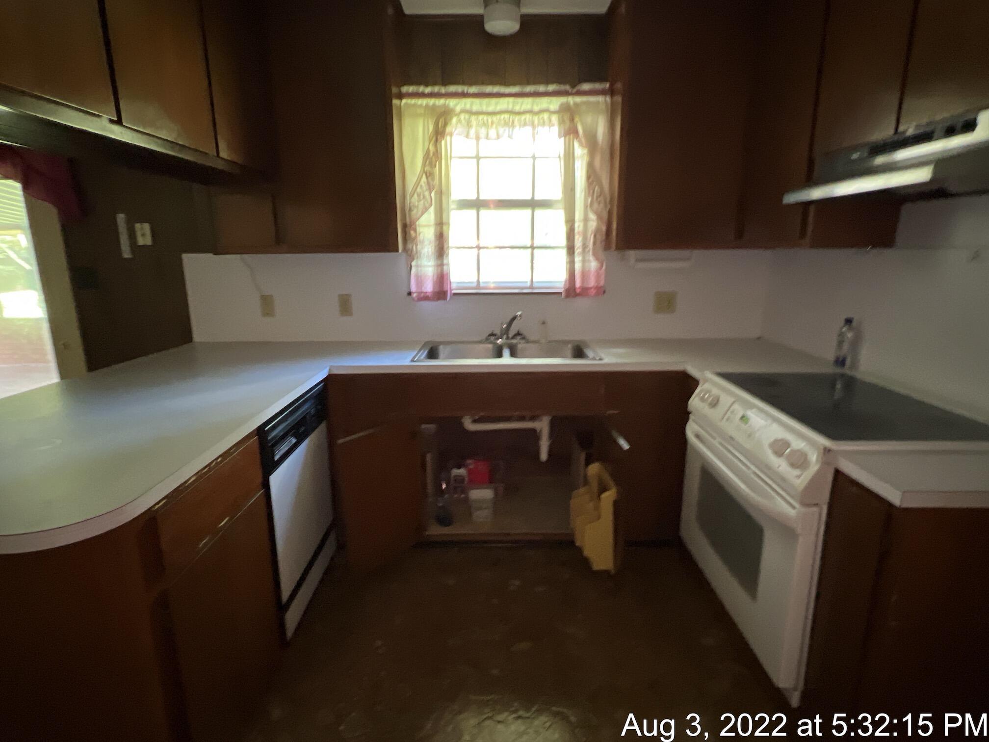 5355 Keyser Mill Road Baker, FL 32531 - Photo 3 of 16 a kitchen with a sink stove and cabinets