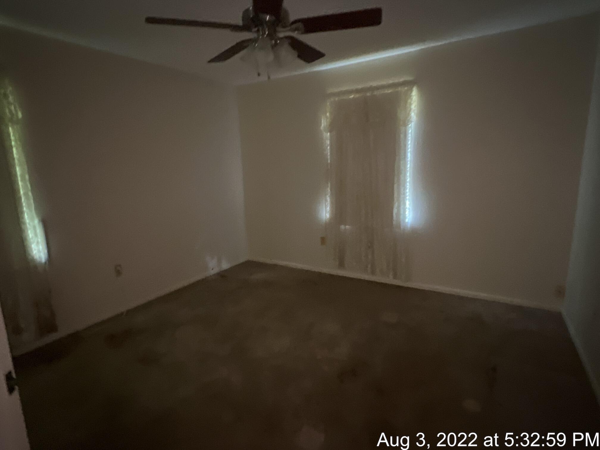 5355 Keyser Mill Road Baker, FL 32531 - Photo 9 of 16 an empty room with a ceiling fan and a window