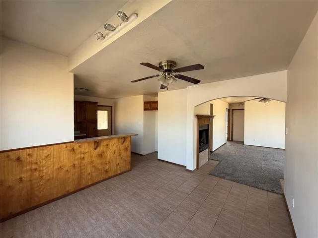 a view of a livingroom with wooden floor and a ceiling fan