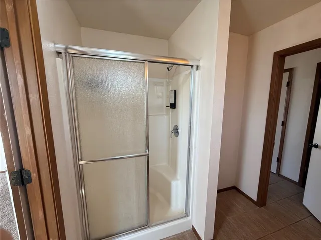a bathroom with a glass shower door