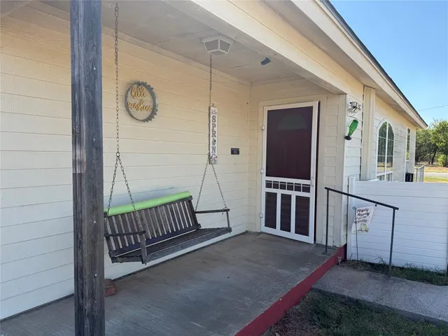 a view of a porch with furniture and front door