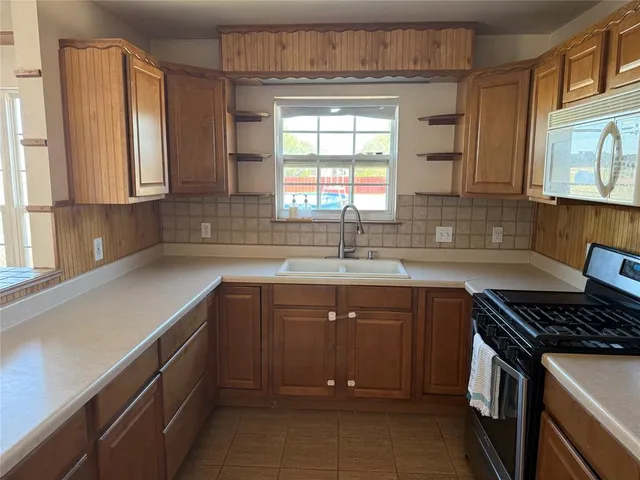 a kitchen with a sink and a stove