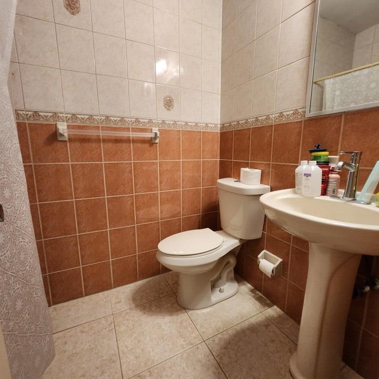 11249 Southwest 169th Street, Unit V4831 Miami, FL 33157 - Photo 14 of 18 a bathroom with a toilet a sink a mirror and vanity