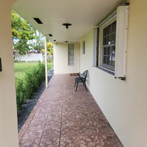 a bath room with a window and a rug
