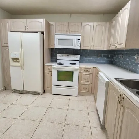 a kitchen with cabinets and appliances