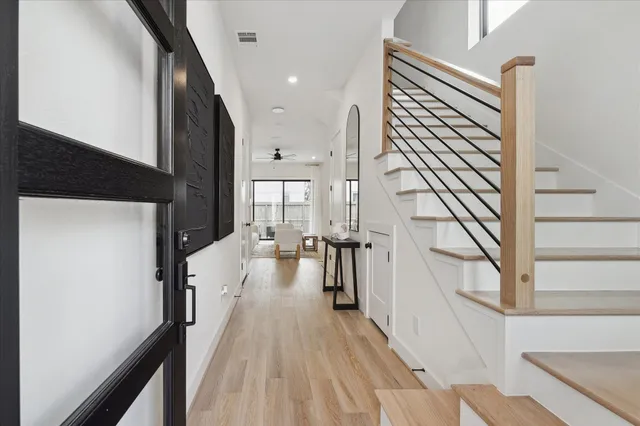 a kitchen with stainless steel appliances kitchen island granite countertop a table chairs and a refrigerator