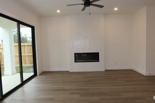 a kitchen with a sink cabinets and wooden floor