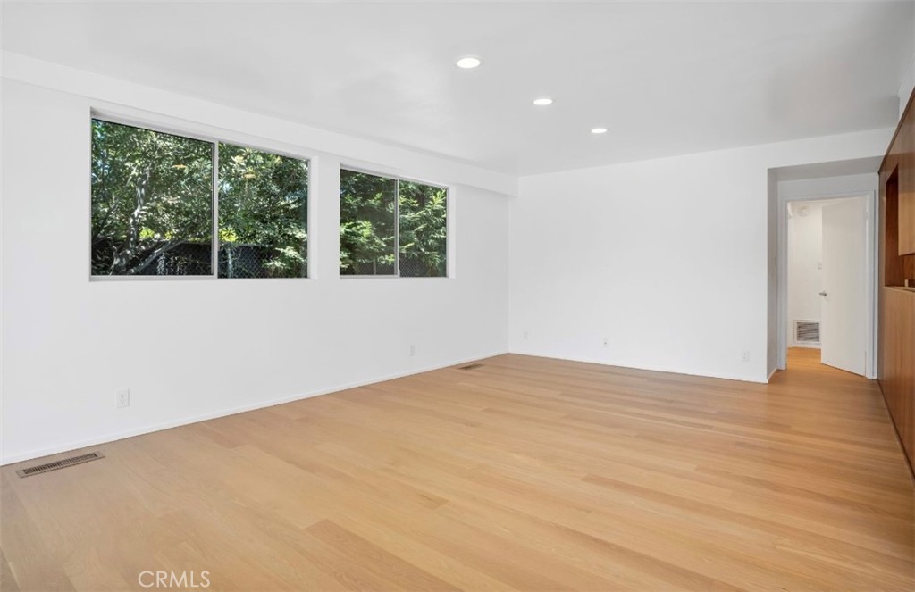16459 Garvin Drive Encino, CA 91436 - Photo 12 of 26 a view of an empty room with wooden floor and a window
