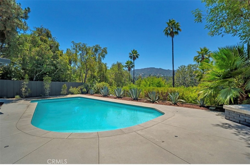 16459 Garvin Drive Encino, CA 91436 - Photo 23 of 26 a view of a swimming pool with a yard