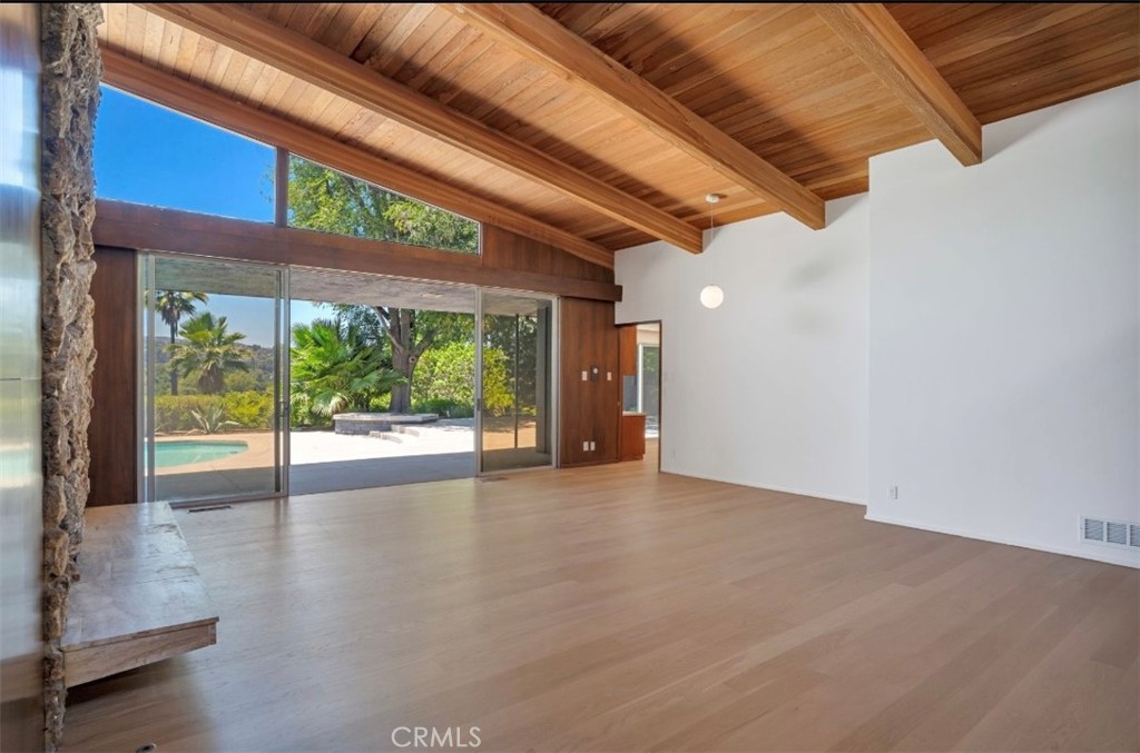 16459 Garvin Drive Encino, CA 91436 - Photo 9 of 26 a view of an empty room with wooden floor and a window