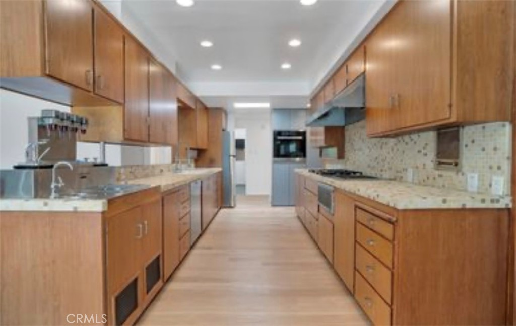 16459 Garvin Drive Encino, CA 91436 - Photo 10 of 26 a large kitchen with stainless steel appliances granite countertop a sink and cabinets