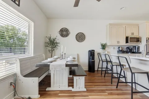 a kitchen with white cabinets stainless steel appliances and sink