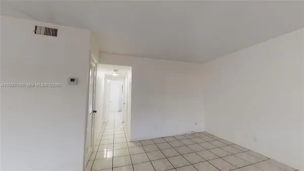 an empty room with windows and closet