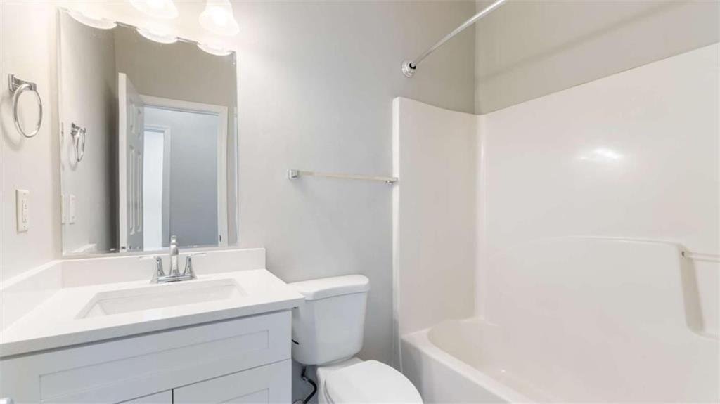 848 Ridge Avenue Northwest, Unit A Atlanta, GA 30318 - Photo 12 of 26 a bathroom with a sink toilet and shower